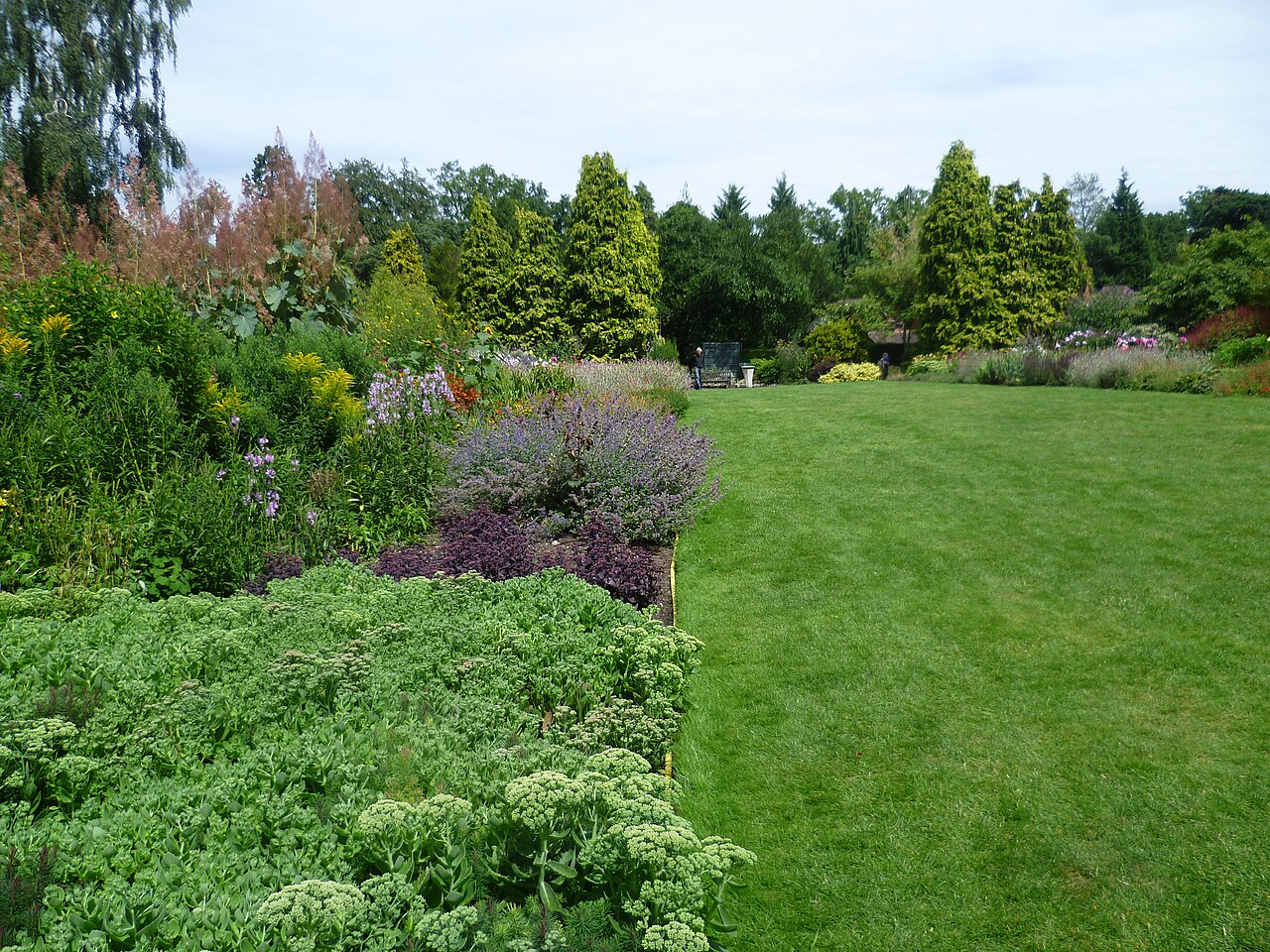 Flower borders and lawns in the gardens at Coombe Wood, Croydon