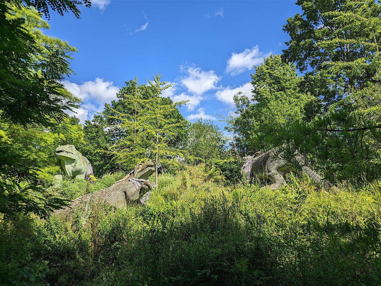 The Victorian dinosaur sculptures among summer greenery in Crystal Palace Park