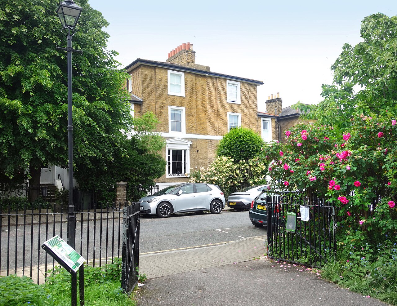 Roses in bloom by the gate of Slade Gardens in Stockwell